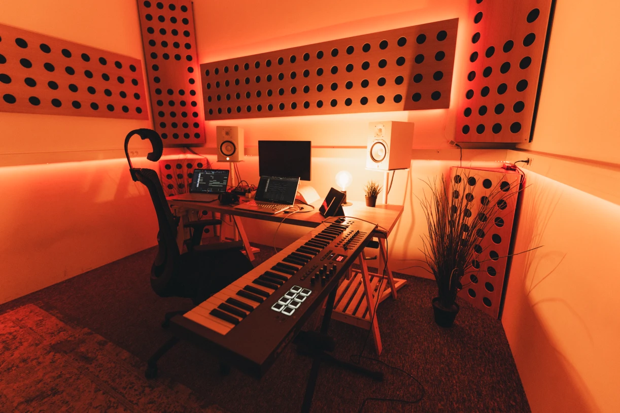 Photo of artists producing and playing in a beatmaking studio